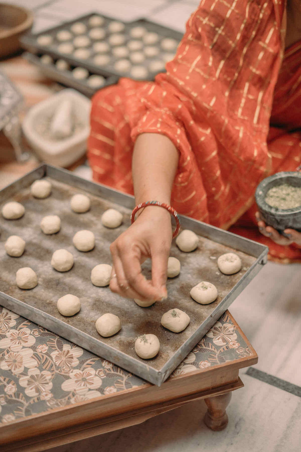 Hand-portioned atta cookie dough on a baking tray