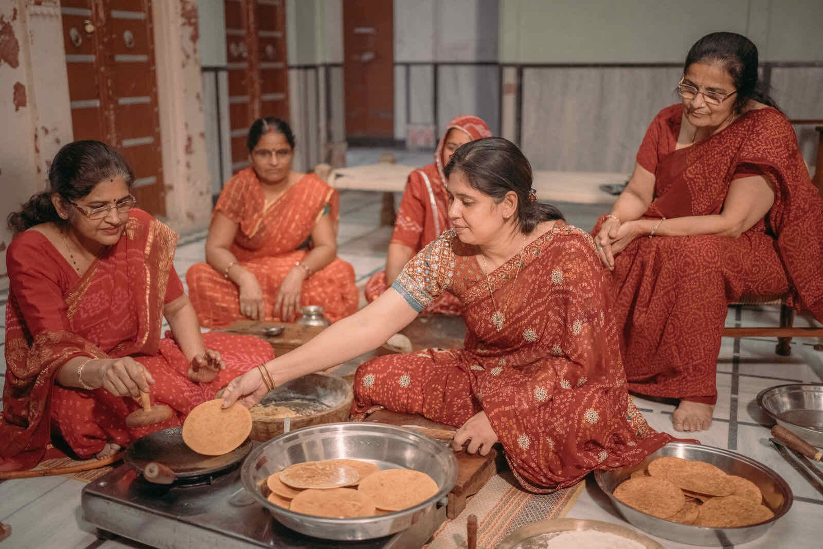 A family sharing Munchingo cookies from a thali
